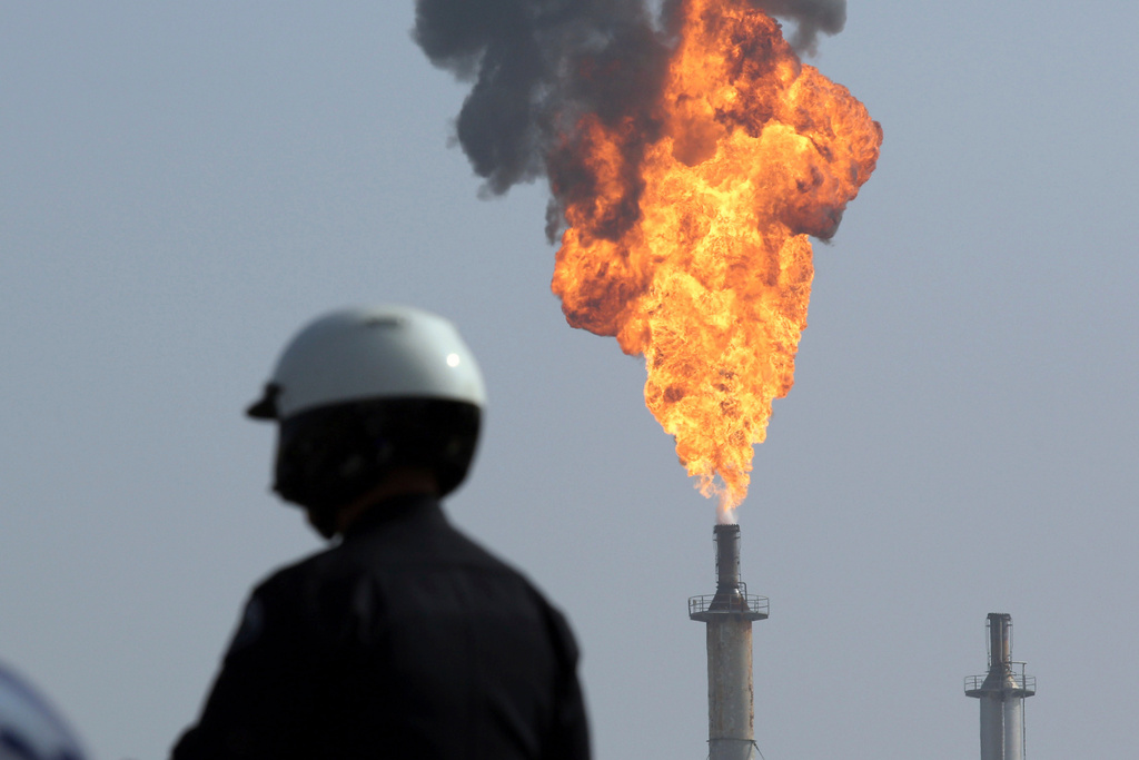 FILE - A very large smokestack flare burns off flammable product after an explosion in a processing facility at the ExxonMobil refinery in Torrance, Calif., on Feb. 18, 2015. (Chuck Bennett//The Orange County Register via AP, File)