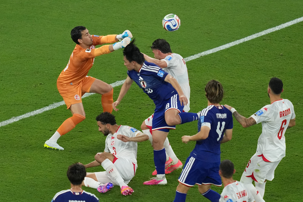 Tunisia goalkeeper Aymen Dahmen blocks a charge by Japan's Ayase Ueda during a World Cup Group F soccer match in Guadalupe, near Monterrey, Mexico, Saturday, June 20, 2026. (AP Photo/Moises Castillo)