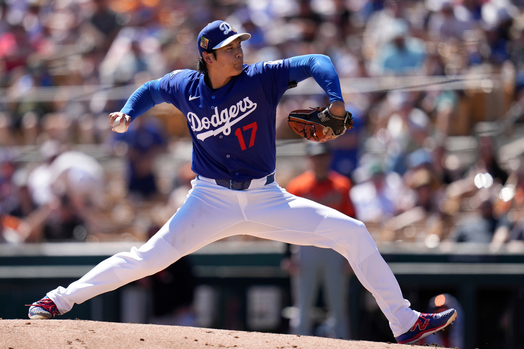 Los Angeles Dodgers starting pitcher Shohei Ohtani, of Japan, throws against the San Francisco Giants during the second inning of a spring training baseball game, Wednesday, March 18, 2026, in Phoenix. (AP Photo/Ross D. Franklin)