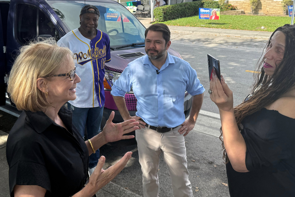 Senator Ruben Gallego, center, campaigns with Eileen Higgins during her campaign for Miami Mayor on Sunday, Dec. 7, 2025 in Miami. (AP Photo/Adriana Gomez)