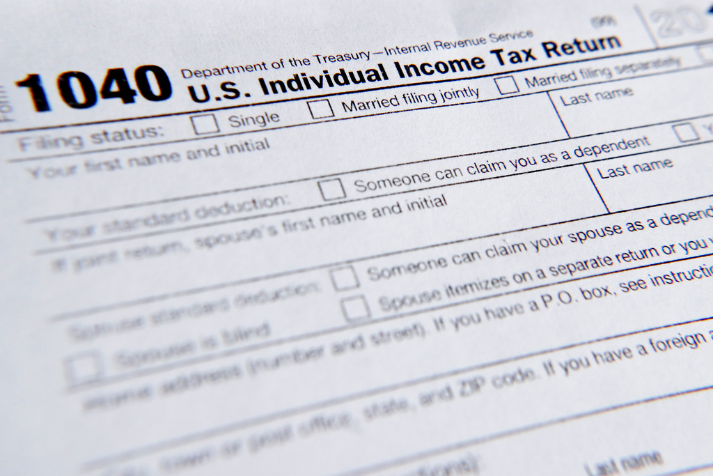FILE - A 1040 tax form printed from the Internal Revenue Service web page is seen, Feb. 13, 2019, in Zelienople, Pa. (AP Photo/Keith Srakocic, File)