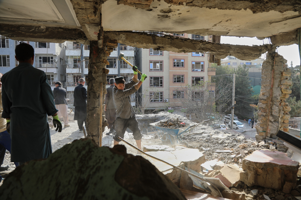 Residents remove debris from a house damaged by Wednesday's two drone strikes, in Kabul, Afghanistan, Thursday, Oct. 16, 2025. (AP Photo/Siddiqullah Alizai)