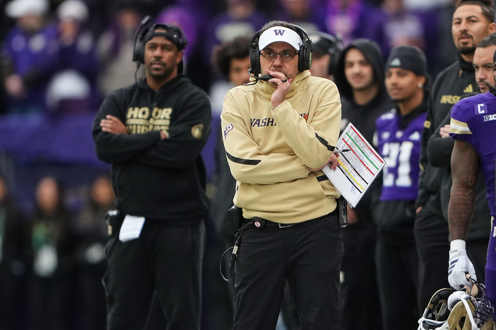 FILE - Washington head coach Jedd Fisch watches from the sideline during the first half of an NCAA college football game against Oregon, Nov. 29, 2025, in Seattle. (AP Photo/Lindsey Wasson, File)