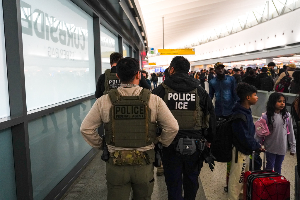 Federal immigration agents walk through Terminal 5 at John F. Kennedy International Airport (JFK) in the Queens borough of New York, Monday, March 23, 2026. (AP Photo/Ryan Murphy)