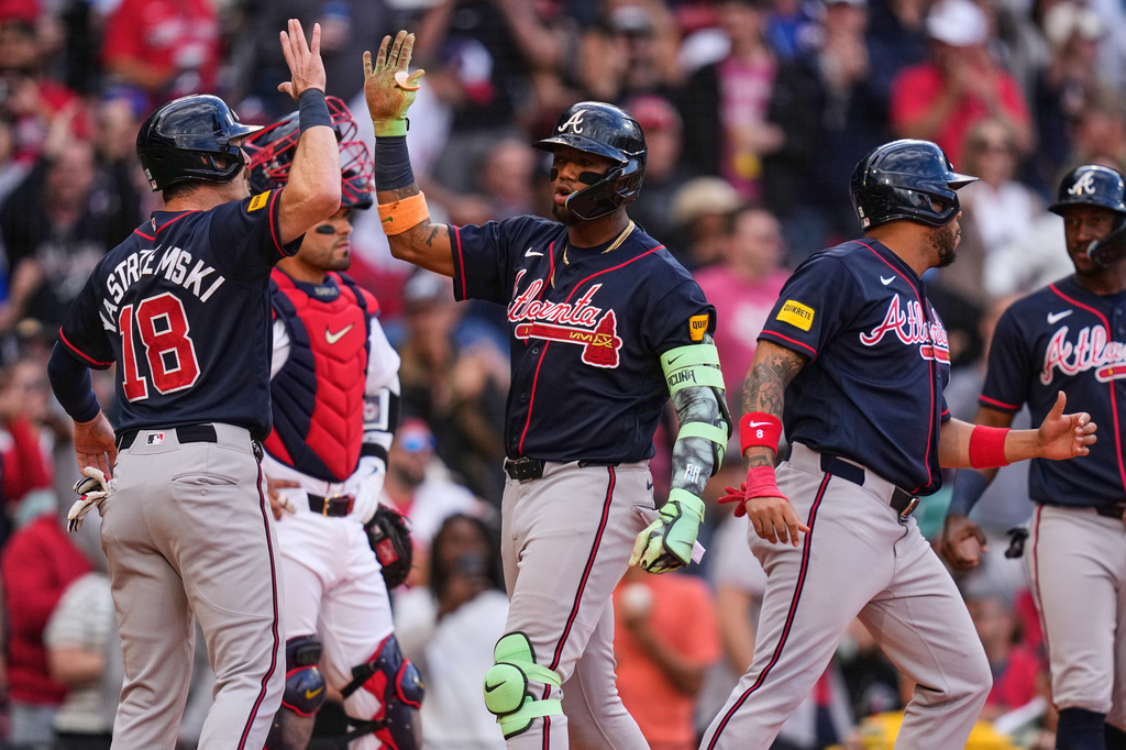 Atlanta Braves' Ronald Acuña Jr., center, is congratulated by Mike Yastrzemski (18) after his grand slam in the sixth inning of a baseball game against the Boston Red Sox, Thursday, May 28, 2026, in Boston. (AP Photo/Charles Krupa)