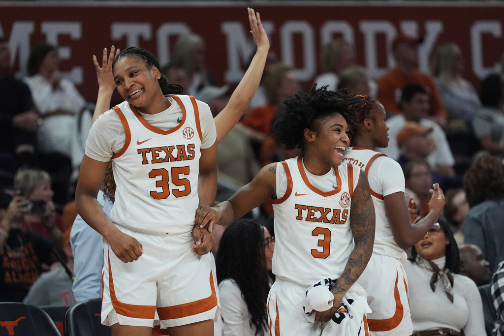Texas forward Madison Booker (35) and guard Rori Harmon (3) celebrate a score against Texas A&M during the second half of an NCAA college basketball game in Austin, Texas, Sunday, Jan. 18, 2026. (AP Photo/Eric Gay)