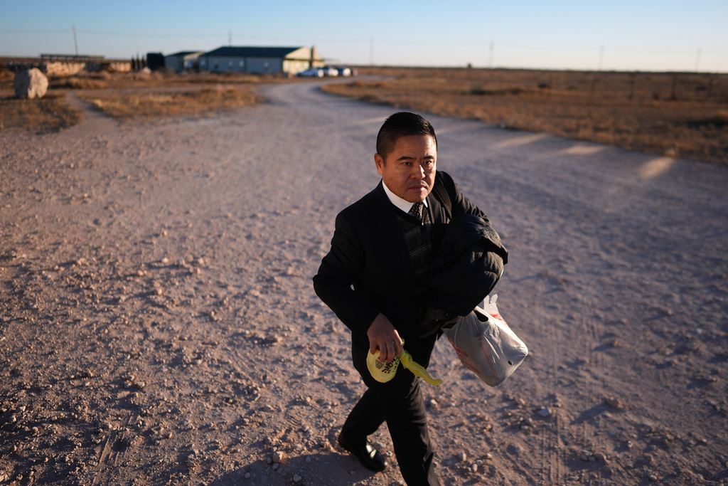 Former Chinese official Li Chuanliang walks between buildings in the Mayflower Church community, in Midland, Texas, Jan. 19, 2025. (AP Photo/Rebecca Blackwell)