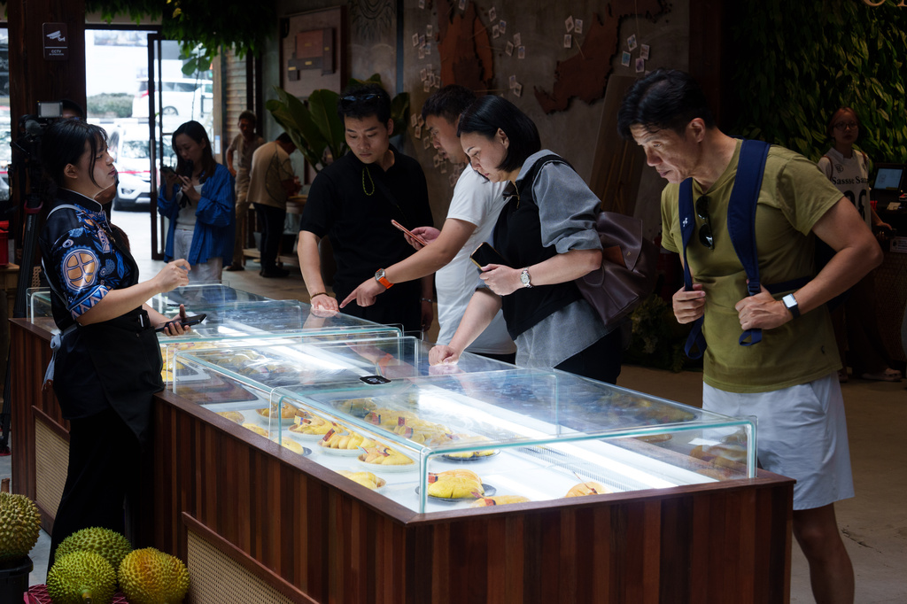 Visitors selecting durian during a tasting session at KLDEX (Kuala Lumpur Durian Experience Centre) in Kuala Lumpur, Malaysia, Friday, June 26, 2026. (AP Photo/Vincent Thian)