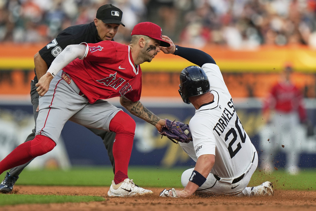 Detroit Tigers' Spencer Torkelson, right, is tagged out at second base by Los Angeles Angels shortstop Zach Neto, front left, during the fifth inning of a baseball game, Saturday, Aug. 9, 2025, in Detroit. (AP Photo/Ryan Sun)