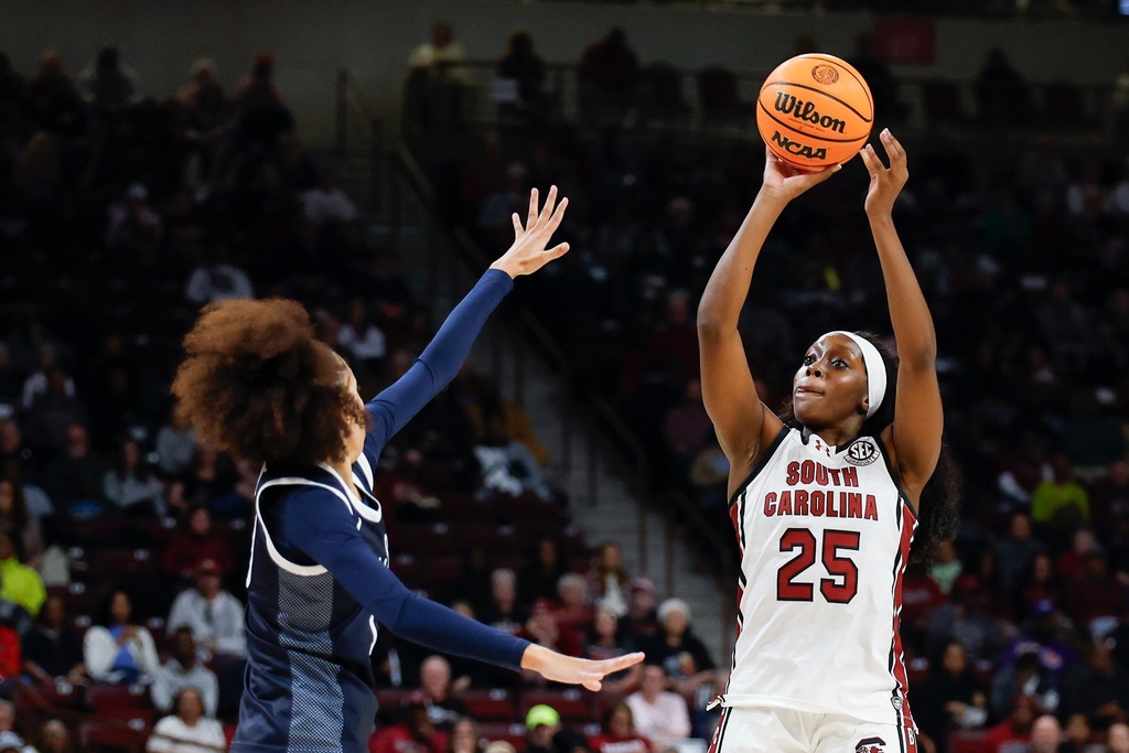 South Carolina guard Raven Johnson (25) looks to shoot over Penn State guard Tea Cleante, left, during the first half of an NCAA college basketball game in Columbia, S.C., Sunday, Dec. 14, 2025. (AP Photo/Nell Redmond)
