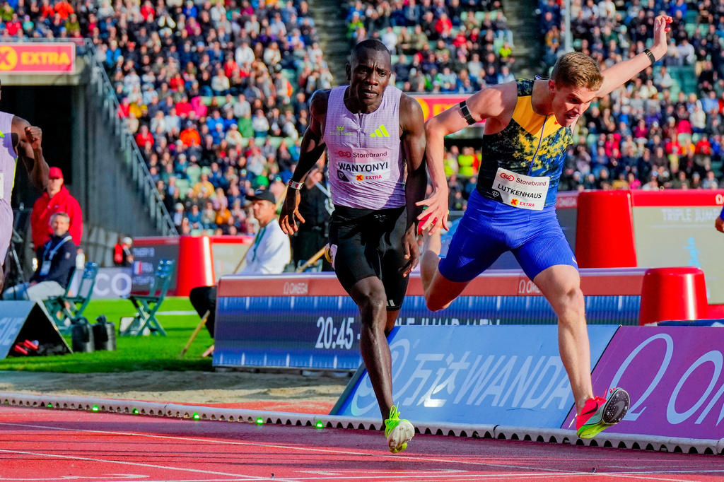 United States' Cooper Lutkenhaus, right, crosses the finish line ahead of Kenya's Emmanuel Wanyonyi to win in the men's 800-meter race at the Diamond League athletics meet at Bislett Stadium in Oslo, Norway, Wednesday, June 10, 2026. (Heiko Junge/NTB Scanpix via AP)