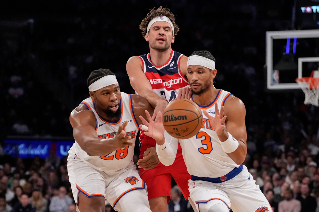New York Knicks forward Guerschon Yabusele (28) and New York Knicks guard Josh Hart (3) drives past Washington Wizards forward Corey Kispert (24) during the first half of an NBA basketball game, Monday, Nov. 3, 2025, in New York. (AP Photo/Yuki Iwamura)