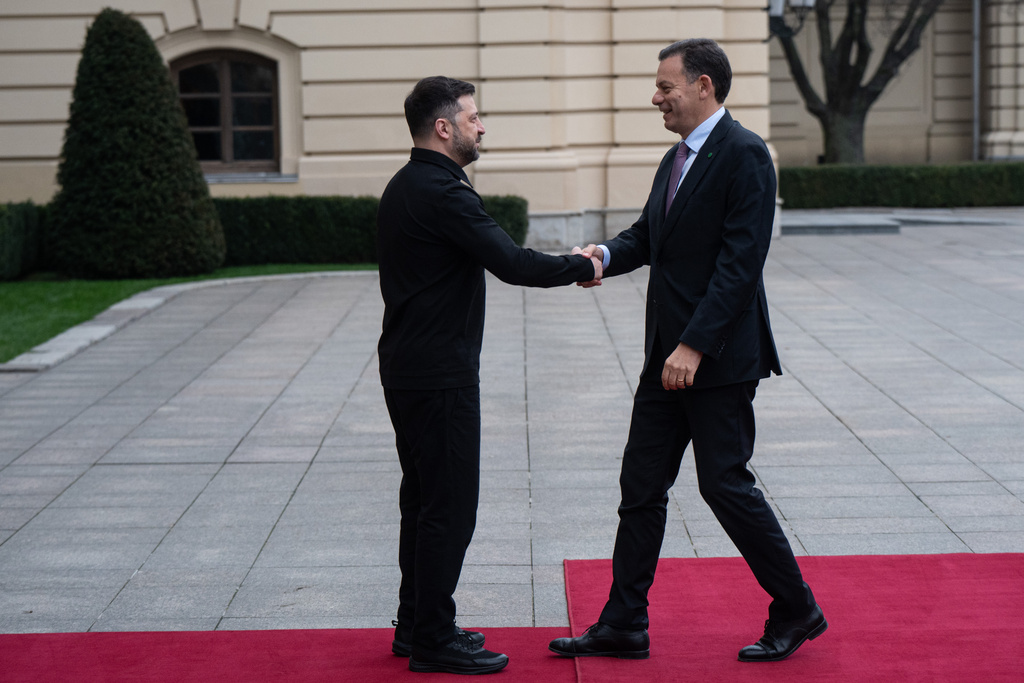 Ukraine's President Volodymyr Zelenskyy, left, shakes hands with Portuguese Prime Minister Luís Montenegro in Kyiv, Ukraine, Saturday, Dec. 20, 2025. (AP Photo/Danylo Antoniuk)