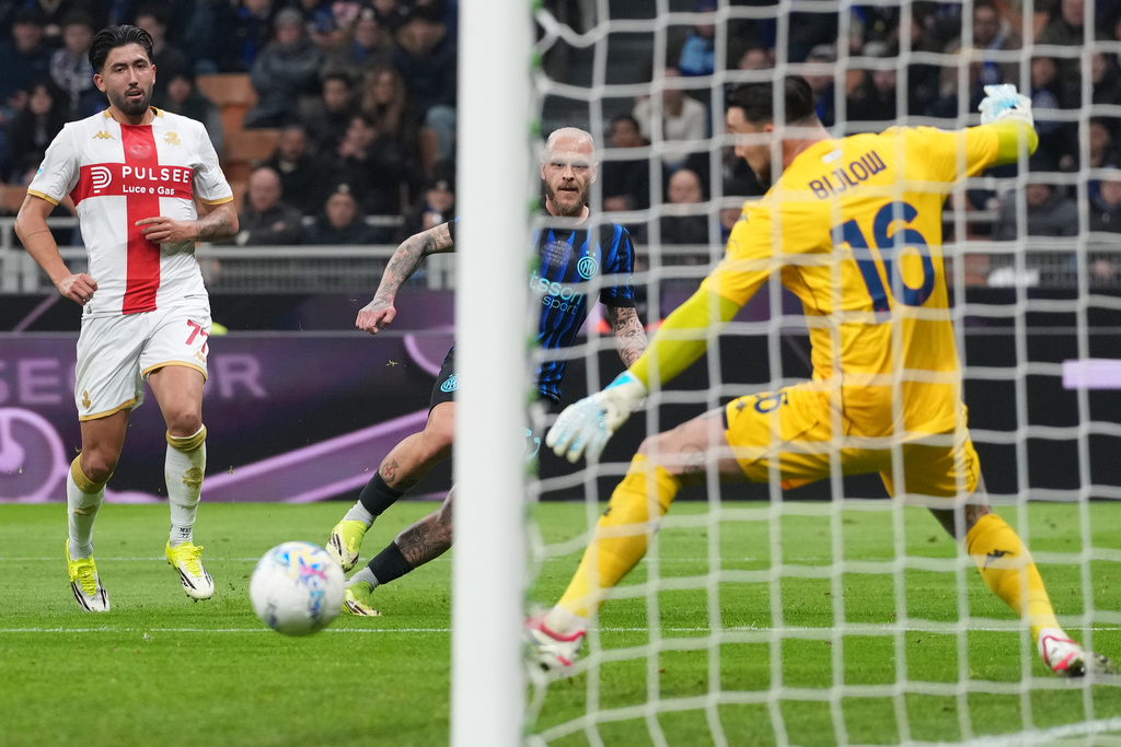 Inter Milan's Federico Dimarco, center, scores his side's opening goal during the Serie A soccer match between Inter Milan and Genoa in Milan, Italy, Saturday, Feb. 28, 2026. (AP Photo/Antonio Calanni)