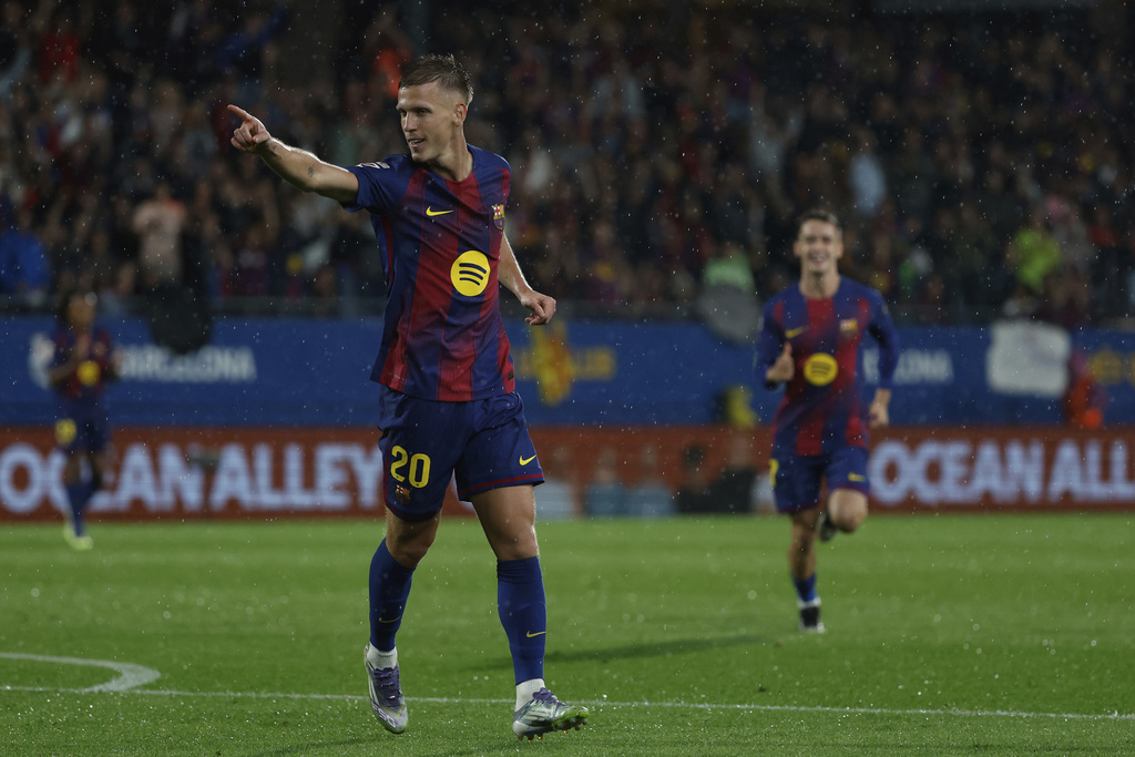 Barcelona's Dani Olmo celebrates his side's third goal during a Spanish La Liga soccer match between FC Barcelona and Getafe at the Johan Cruyff stadium in Barcelona, Spain, Sunday, Sept. 21, 2025. (AP Photo/Joan Monfort)