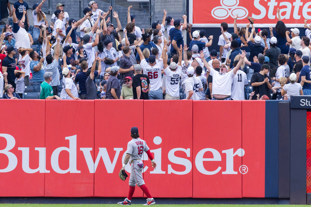 Boston Red Sox left fielder Jarren Duran (16) watches fans react after New York Yankees' Heliot Ramos hit a three-run home run, also scoring Paul Goldschmidt and Cody Bellinger, in the fifth inning of a baseball game, Sunday, Aug. 30, 2026, in New York. (AP Photo/Corey Sipkin)