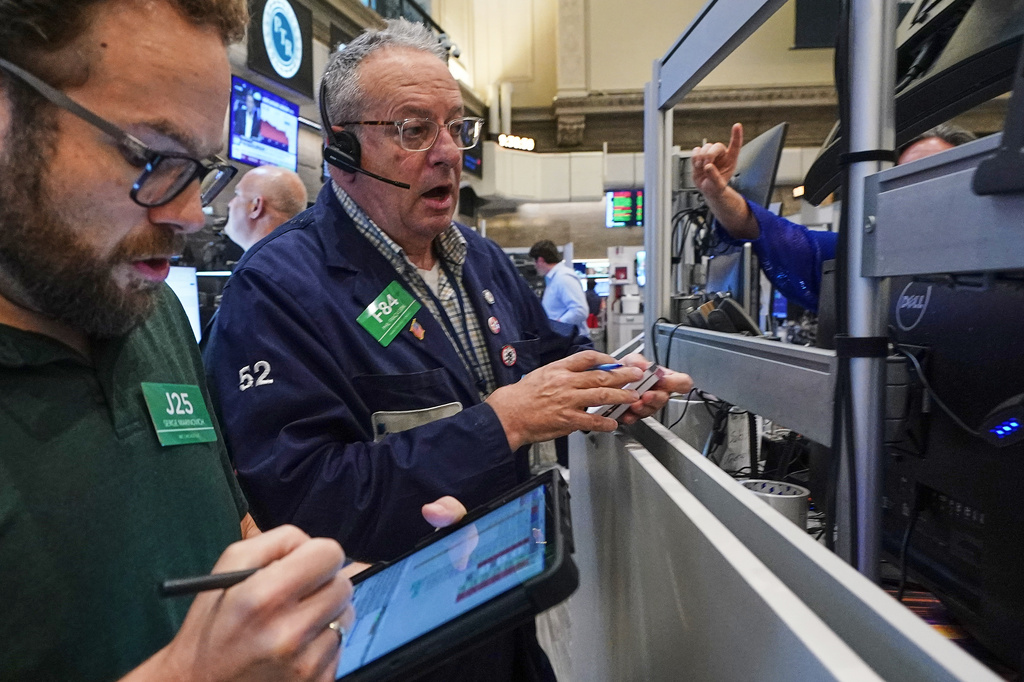 Options traders Serge Marinovich, left, and Phil Phil Fracassini work on the floor of the New York Stock Exchange, Friday, June 26, 2026. (AP Photo/Richard Drew)