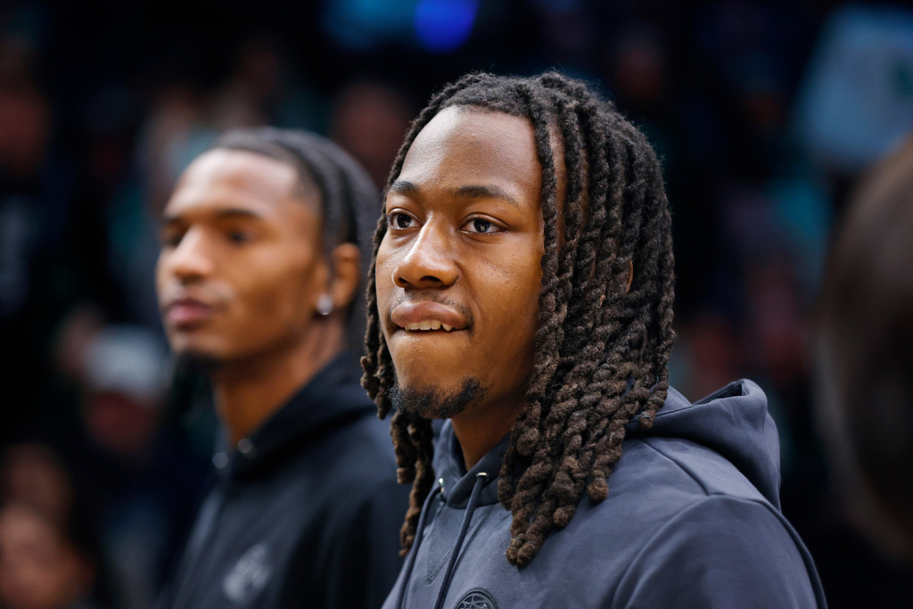 Minnesota Timberwolves guards Ayo Dosunmu, front, and Julian Phillips, rear, look around during a timeout after the first quarter of an NBA basketball game with the New Orleans Pelicans Friday, Feb. 6, 2026, in Minneapolis. The two were traded to Minnesota the day before. (AP Photo/Bruce Kluckhohn)