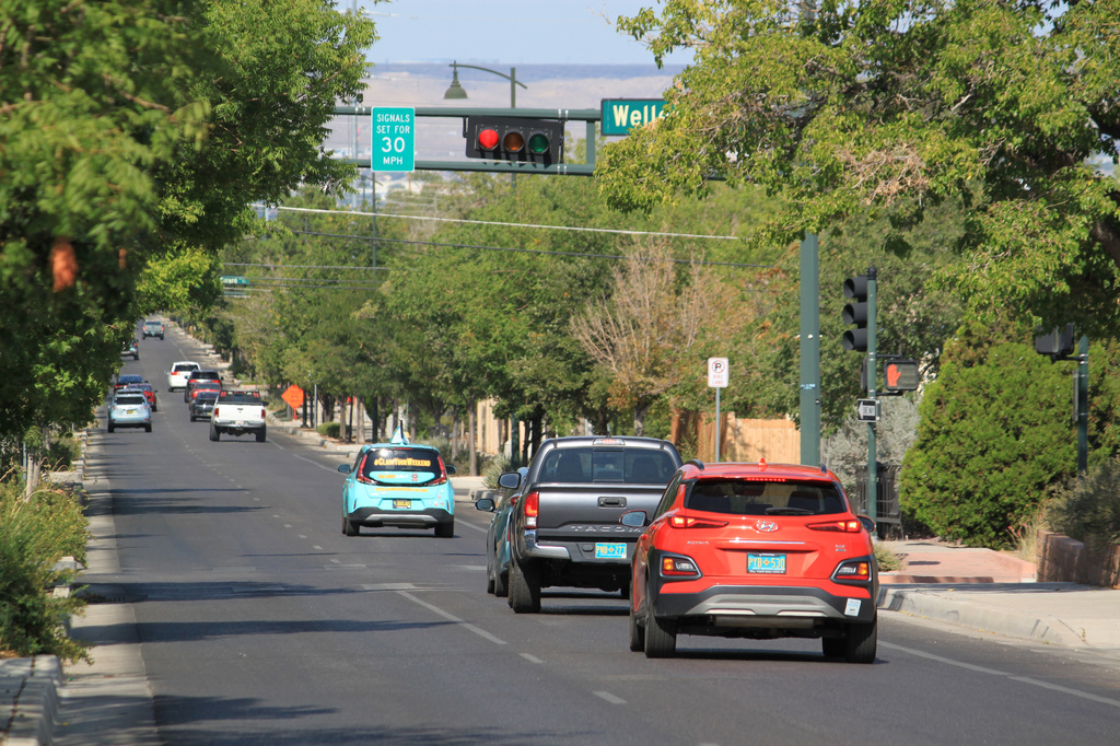 Vehicles stop along Lead Avenue where stoplights are set for a specific speed limit as part of the "rest on red" signal program in Albuquerque, N.M., Wednesday, Aug. 12, 2026. (AP Photo/Susan Montoya Bryan)