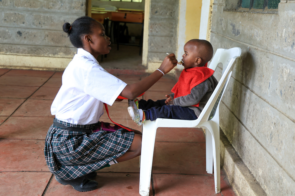 Mary Wanjiku, 20 feeds her son Stephan Keyllin during lunchtime at Greenland Girls School in Kiserian, Kajiado, Kenya, March 5, 2026. (AP Photo/Andrew Kasuku)