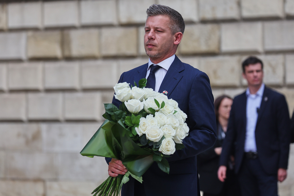 Hungarian Prime Minister Peter Magyar lays down flowers at a monument for late Pope John Paul II, at the Wawel Cathedral during his visit in Krakow, Poland Tuesday, May 19, 2026. (AP Photo/Beata Zawrzel)