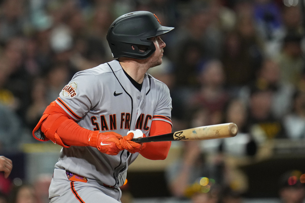 San Francisco Giants' Patrick Bailey watches his RBI single during the fourth inning of a baseball game against the San Diego Padres Monday, March 30, 2026, in San Diego. (AP Photo/Gregory Bull)