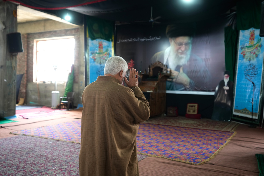 A Shiite Muslim man prays as he arrives to contribute to a relief drive for Iran in Budgam, Indian-controlled Kashmir, Monday, March 23, 2026. (AP Photo/Mukhtar Khan)