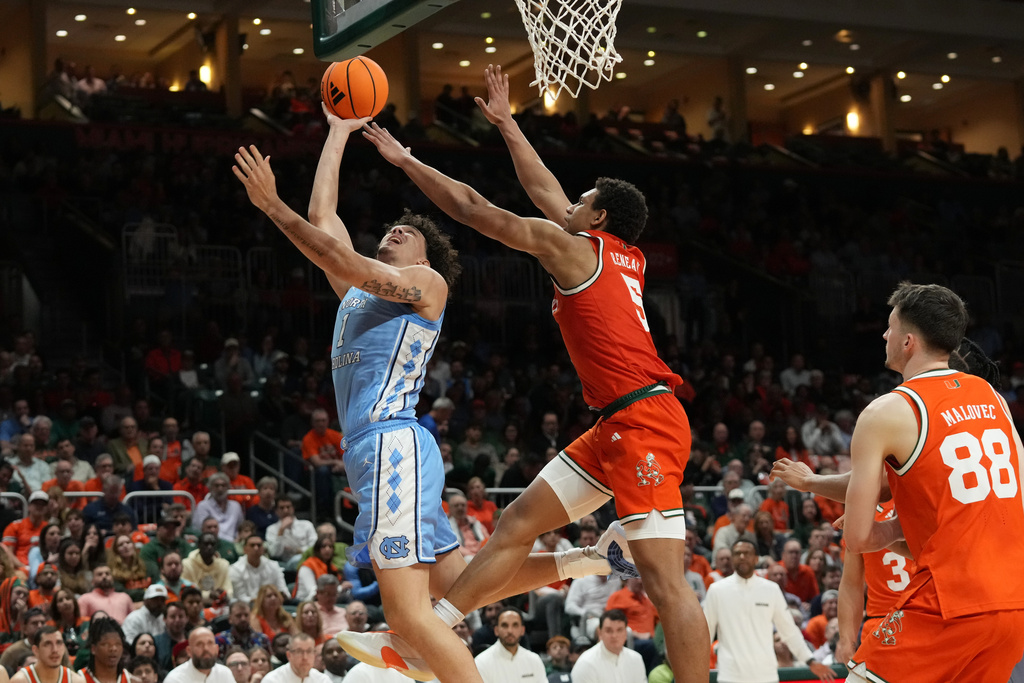 North Carolina forward Zayden High (1) drives to the basket as Miami forward Malik Reneau (5) defends during the first half of an NCAA college basketball game, Tuesday, Feb. 10, 2026, in Coral Gables, Fla. (AP Photo/Marta Lavandier)