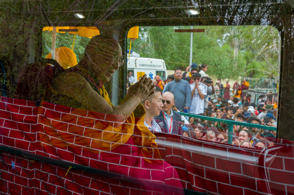 Tibetan spiritual leader the Dalai Lama greets devotees from inside a vehicle as he leaves after attending his birthday celebrations in Leh, India, Monday, July 6, 2026. (AP Photo/Tenzin Choejor)