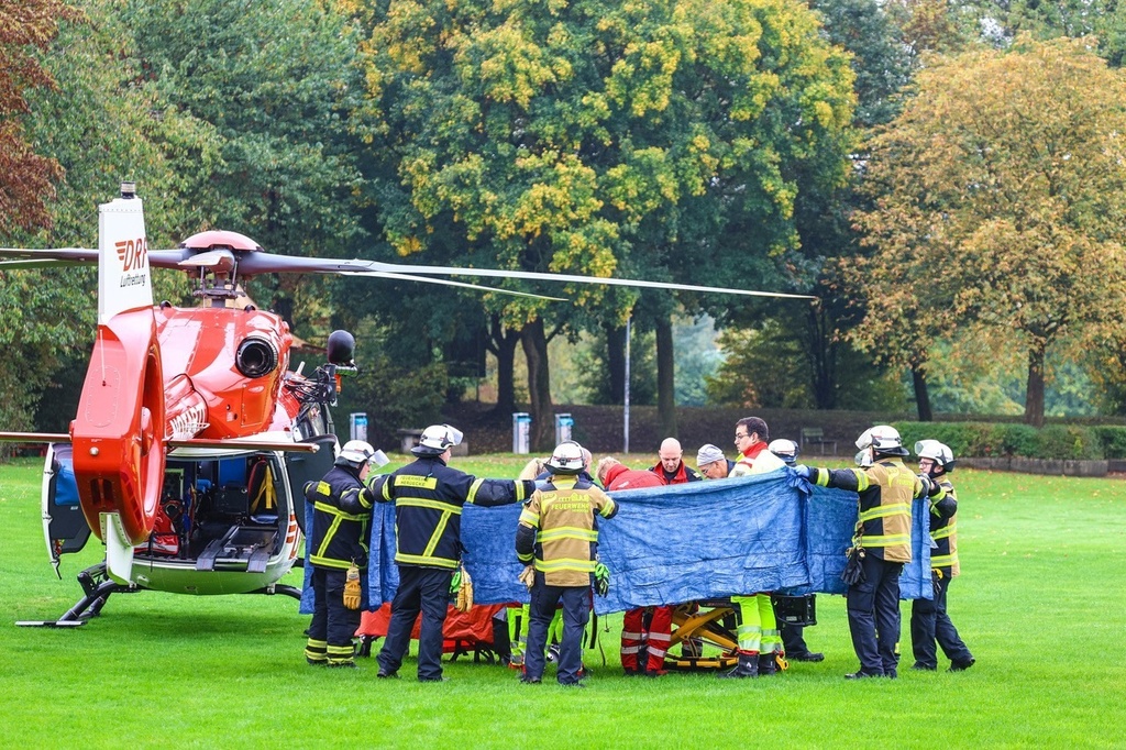 Emergency services stand next to a rescue helicopter in Herdecke, Germany, Tuesday, Oct. 7, 2025, after the newly elected mayor of Herdecke, Iris Stalzer, has been found critically injured in her apartment. (Alex Talash/dpa via AP)