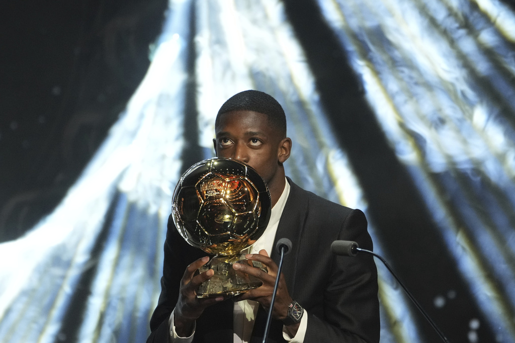 Paris Saint-Germain's Ousmane Dembélé receives the 2025 Men's Ballon d'Or during the 69th Ballon d'Or awards ceremony at the Theatre du Chatelet in Paris, Monday, Sept. 22, 2025. (AP Photo/Thibault Camus)