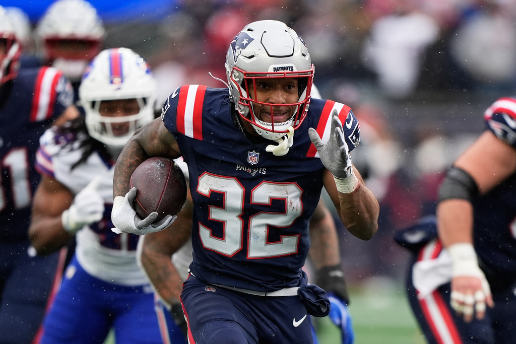 New England Patriots running back Treveyon Henderson (32) runs toward the end zone to score against the Buffalo Bills during the first half of an NFL football game in Foxborough, Mass., Sunday, Dec. 14, 2025. (AP Photo/Robert F. Bukaty)
