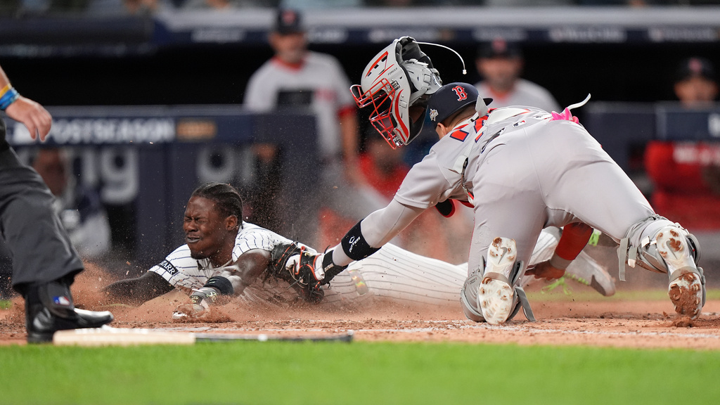 New York Yankees Jazz Chisholm Jr. slides safely into home plate ahead of the tag from Boston Red Sox catcher Carlos Narváez (75) during the eighth inning of Game 2 of an American League wild-card baseball playoff series, Wednesday, Oct. 1, 2025, in New York. (AP Photo/Frank Franklin II)