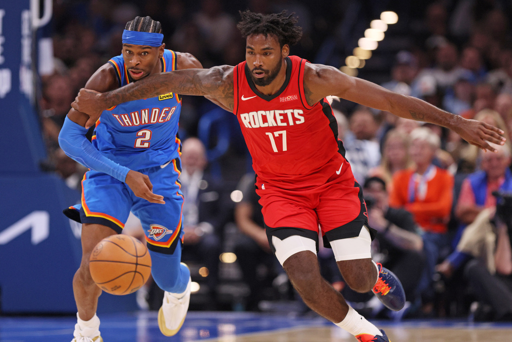 Oklahoma City Thunder guard Shai Gilgeous-Alexander (2) and Houston Rockets forward Tari Eason (17) chase the ball during the first half of an NBA basketball game Tuesday, Oct. 21, 2025, in Oklahoma City. (AP Photo/Nate Billings)