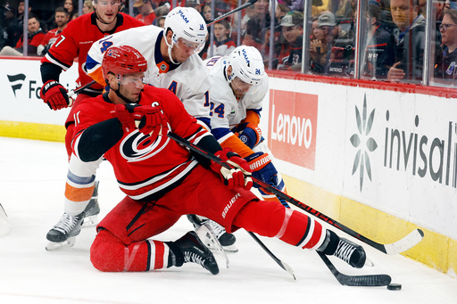 Carolina Hurricanes' Jordan Staal (11) protects the puck from New York Islanders' Bo Horvat (14) and Scott Mayfield (24) during the second period of an NHL hockey game in Raleigh, N.C., Thursday, Oct. 30, 2025. (AP Photo/Karl DeBlaker) Carolina Hurricanes' Jordan Staal (11) protects the puck from New York Islanders' Bo Horvat (14) and Scott Mayfield (24) during the second period of an NHL hockey game in Raleigh, N.C., Thursday, Oct. 30, 2025. (AP Photo/Karl DeBlaker)