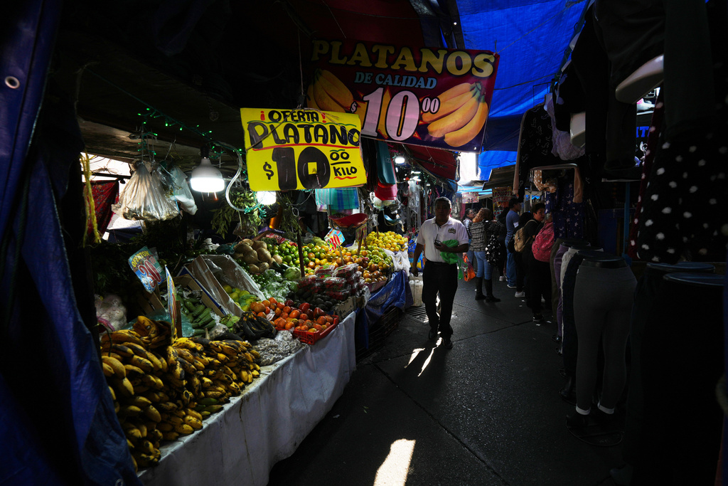 A shopper walks through the open-air Tacubaya market in Mexico City, Wednesday, Jan. 7, 2026. (AP Photo/Marco Ugarte)