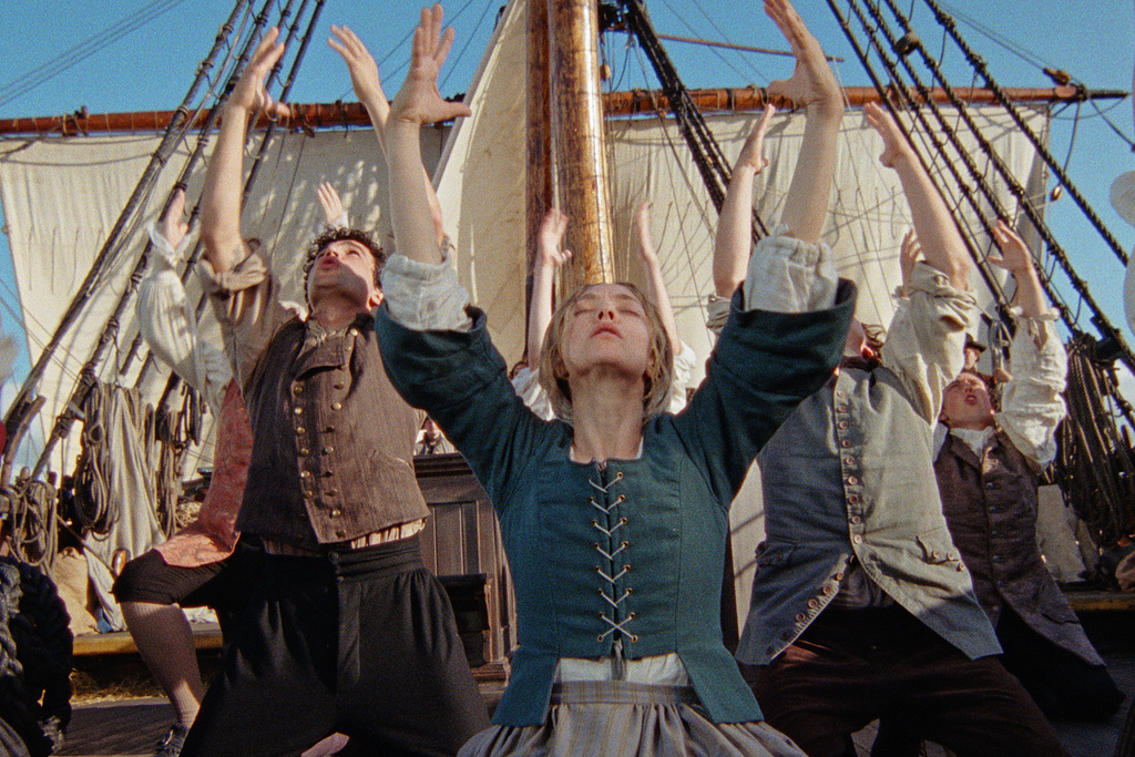 This image released by Searchlight Pictures shows Amanda Seyfried, center, in a scene from "The Testament of Ann Lee." (Searchlight Pictures via AP)