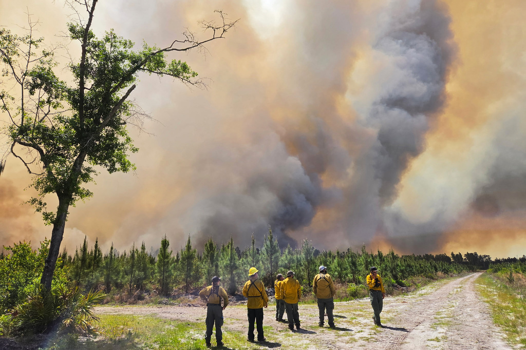 This photo provided by the Georgia Department of Natural Resources shows firefighters responding to the Pineland Road Fire in southeast Georgia on Wednesday, April 22, 2026. (Georgia Department of Natural Resources via AP)