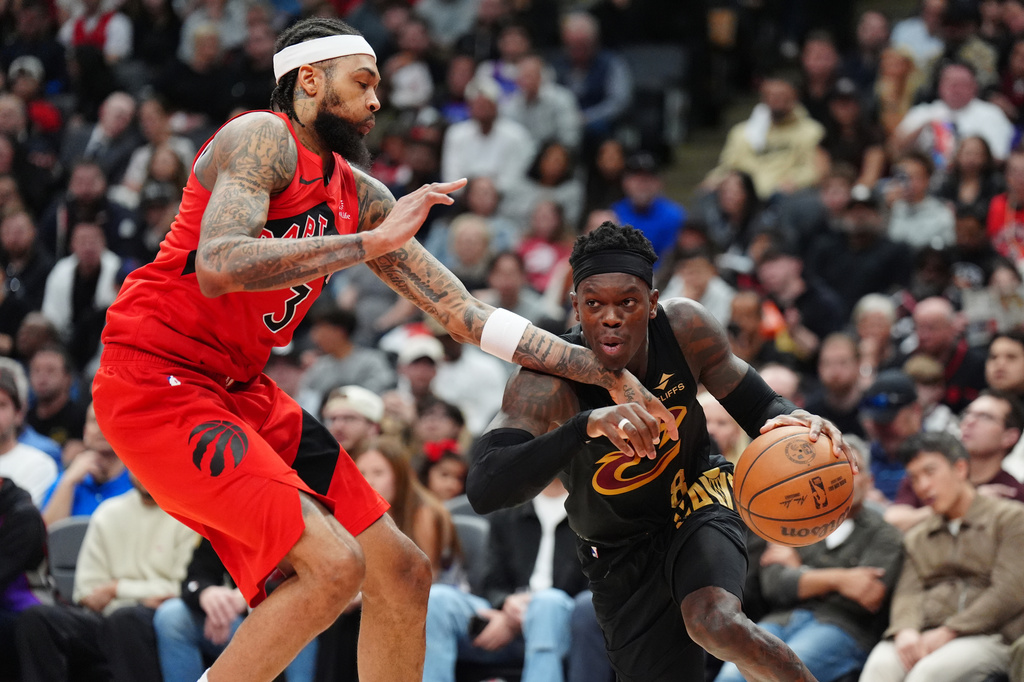Cleveland Cavaliers guard Dennis Schroder, right, drives against Toronto Raptors forward Brandon Ingram (3) during the first half of Game 4 in a first-round NBA basketball playoffs series in Toronto, Sunday, April 26, 2026. (Frank Gunn/The Canadian Press via AP)