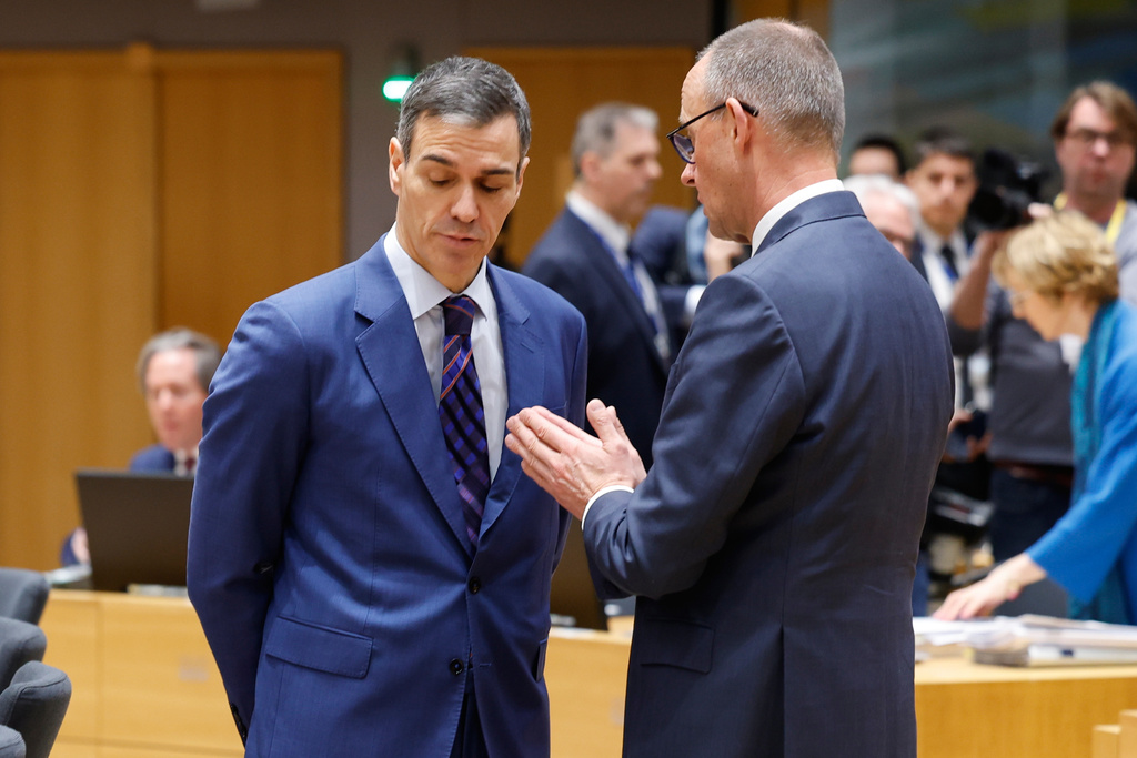 Germany's Chancellor Friedrich Merz, right, speaks with Spain's Prime Minister Pedro Sanchez during a round table meeting at the EU summit in Brussels, Thursday, March 19, 2026. (AP Photo/Geert Vanden Wijngaert)