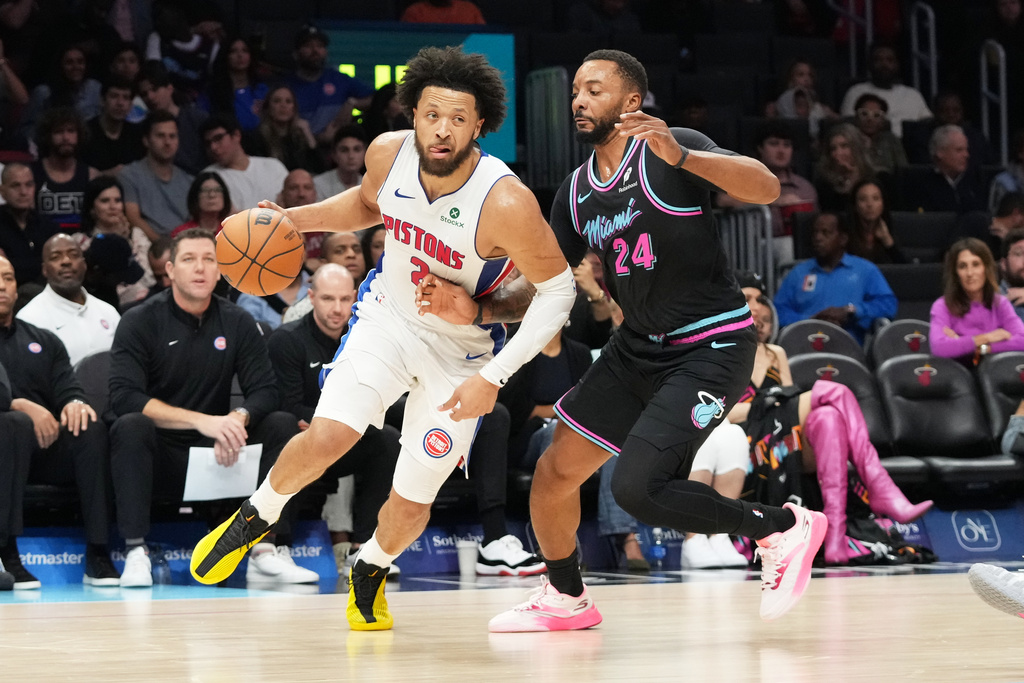 Miami Heat guard Norman Powell (24) defends Detroit Pistons guard Cade Cunningham (2) during the first half of an NBA basketball game Saturday, Nov. 29, 2025, in Miami. (AP Photo/Marta Lavandier)