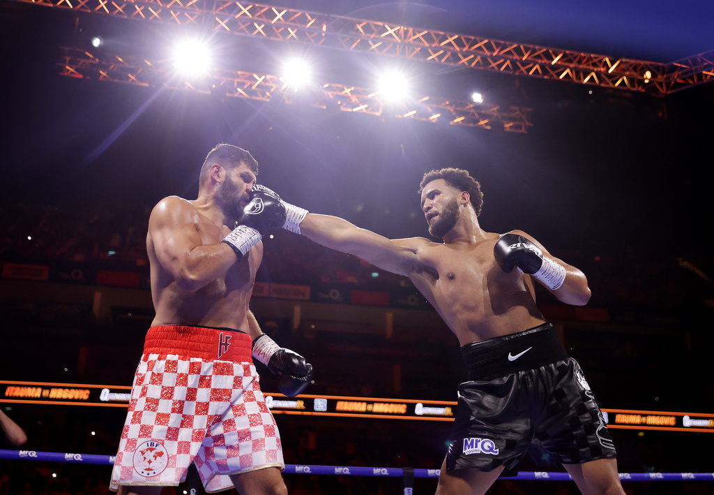 Boxer Moses Itauma, right, punches Filip Hrgovic during their vacant IBF world heavyweight title, Saturday, Aug. 29, 2026, in London. (Steven Paston/PA via AP)