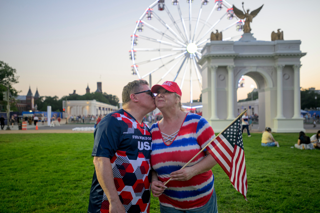 Todd Shaw, left, kisses his wife Shannon Shaw, right, as they pose for portrait during the Great American State Fair on the National Mall, Thursday, July 2, 2026, in Washington. (AP Photo/Rod Lamkey, Jr.)