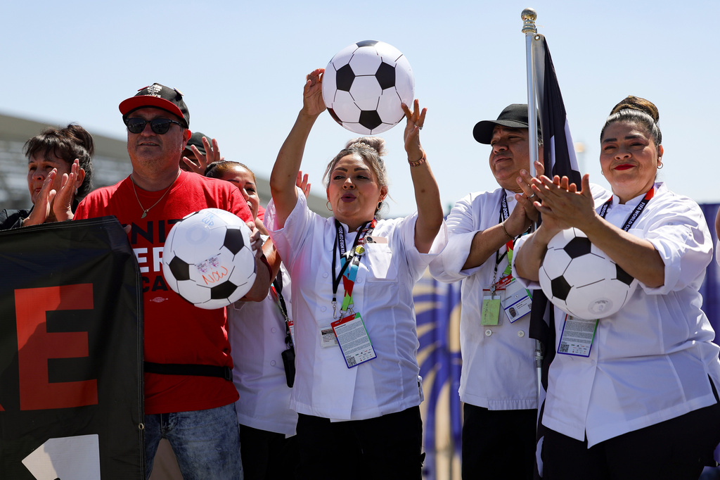 Food and beverage workers cheer during a news conference represented by UNITE HERE Local 11 in front of Sofi Stadium Tuesday, Jun. 9, 2026 in Inglewood, Calif. (AP Photo/Ryan Sun)
