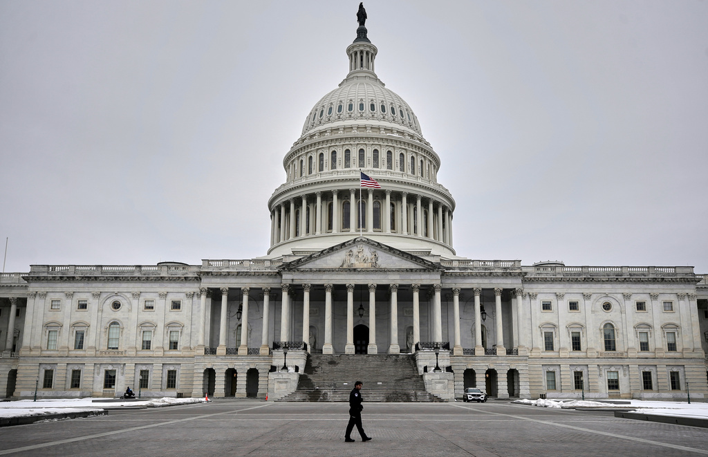 A U.S. Capitol Police officer patrols on the East Front of the U.S. Capitol, Friday, Feb. 6, 2026, in Washington. (AP Photo/Rahmat Gul)