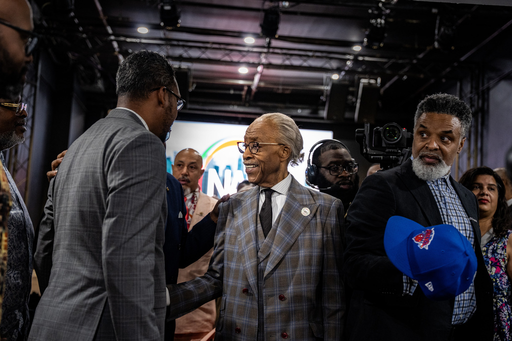 The Rev. Al Sharpton shakes hands with National Action Network (NAN) board members and other invited guests at an event welcoming people to the new location of the NAN House of Justice on Tuesday, June 16, 2026 in New York. (AP Photo/Anna Connors)