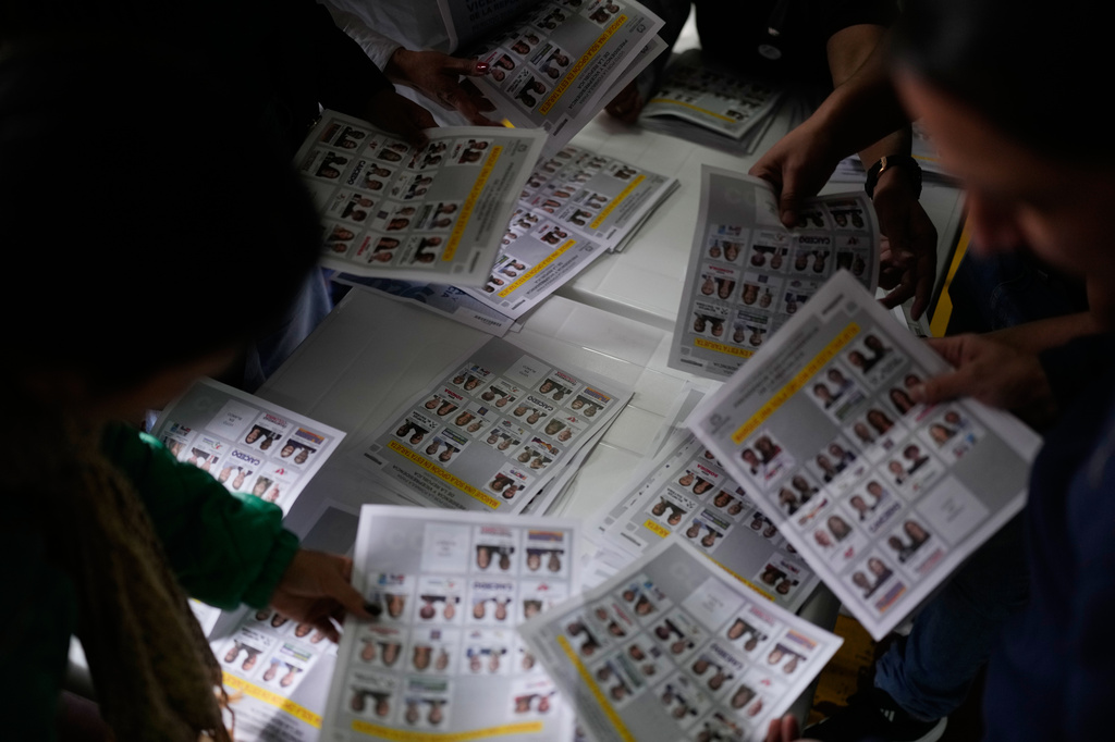 Election officials count ballots after polls closed during the presidential election in Bogota, Colombia, Sunday, May 31, 2026. (AP Photo/Matias Delacroix)