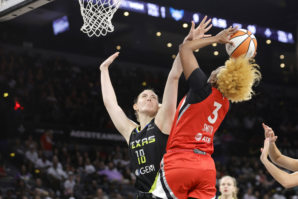 Dallas Wings center Luisa Geiselsoder (18) defends against Las Vegas Aces forward NaLyssa Smith (3) during the first half of a WNBA basketball game Sunday, Aug. 17, 2025, in Las Vegas. (Steve Marcus/Las Vegas Sun via AP)