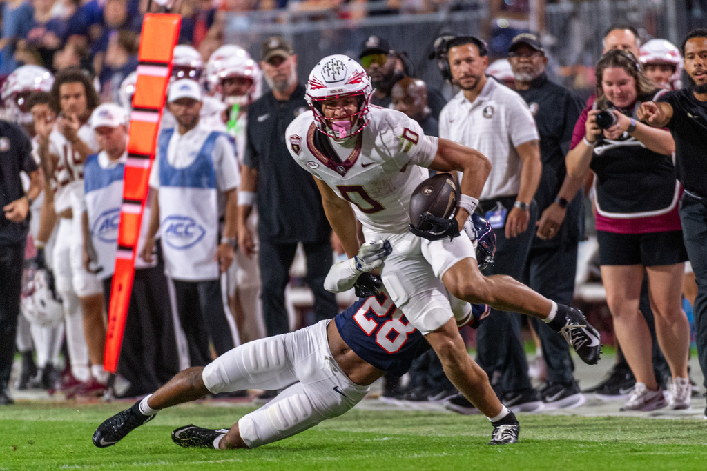 Florida State wide receiver Duce Robinson (0) receives the ball runs downfield during the first half of an NCAA college football game, Friday, Sept. 26 2025, in Charlottesville, Va. (AP Photo/Robert Simmons)