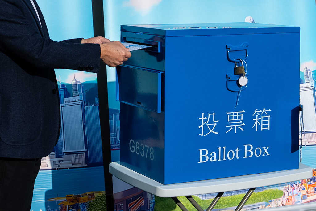 Hong Kong's Chief Executive John Lee casts his ballot at a polling station during the Legislative Council General Election in Hong Kong on Sunday, Dec. 7, 2025. (AP Photo/Chan Long Hei)